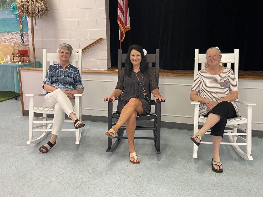 3 women sitting in rocking chairs